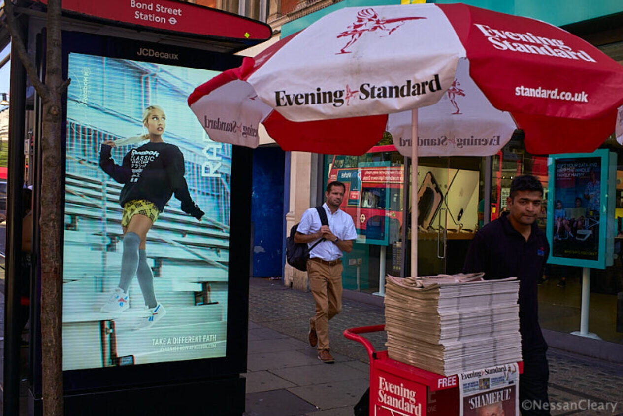 This digital screen on a bus shelter meets old school outdoor advertising.