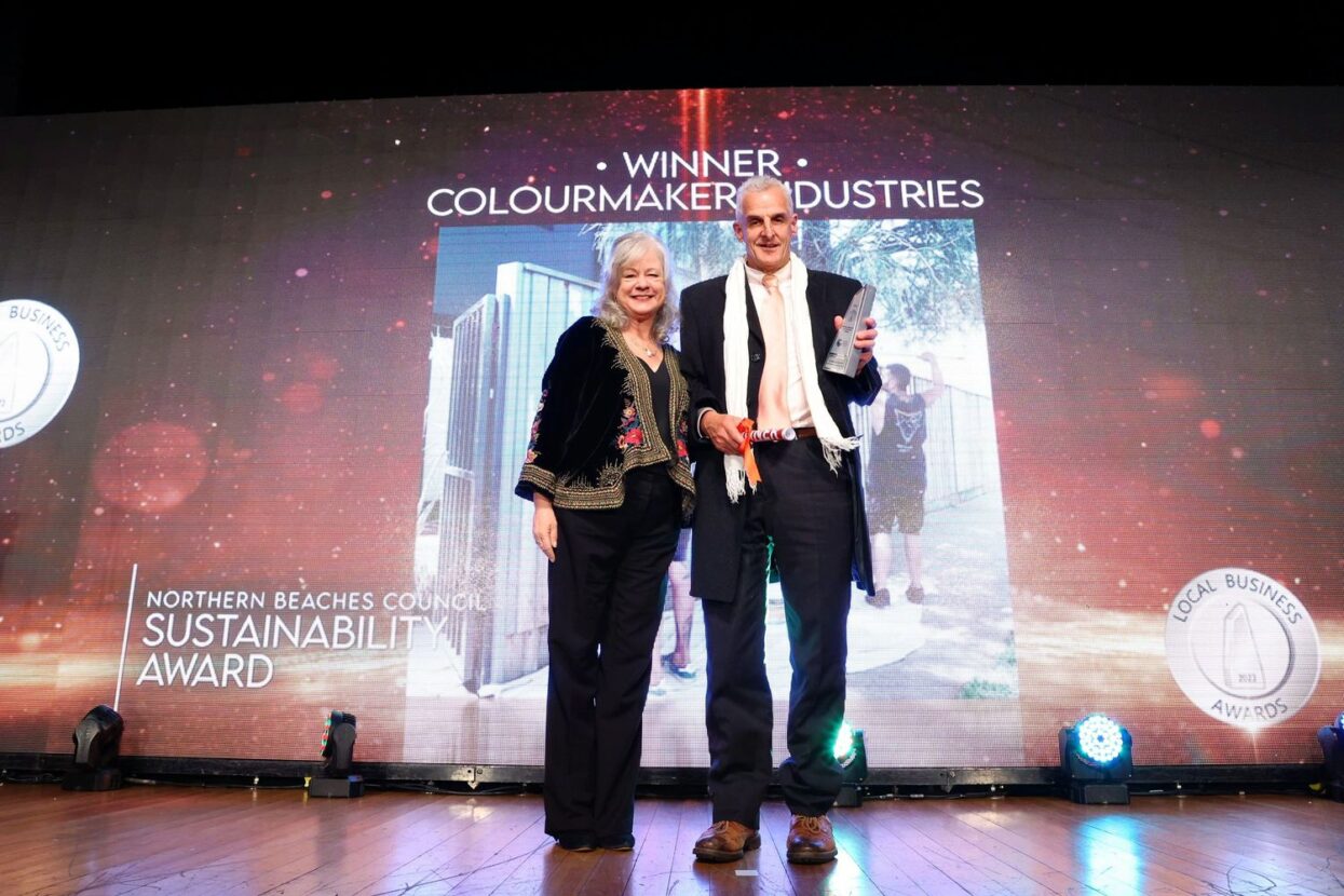 David-and-Sue-Heins-banner-in-background-with-Award-2
